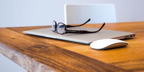 Das Bild zeigt ein zugeklapptes Notebook sowie eine abgelegte Brille. Es steht für die Freizeit, die mit den Anleitungen von web2use.ch geschaffen werden kann.